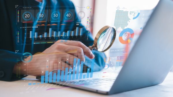 Businessman Holding Magnifying Glass Looking At Virtual Data Chart Dashboard