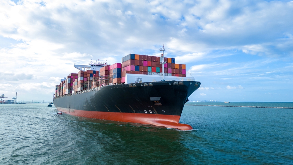 Aerial Side View Of Cargo Ship Carrying Containers
