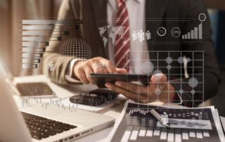 Businessman Using Digital Tablet Analyzes Business Data