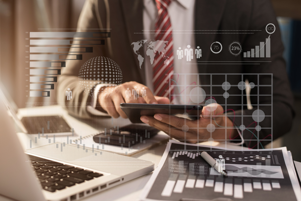 Businessman Using Digital Tablet Analyzes Business Data