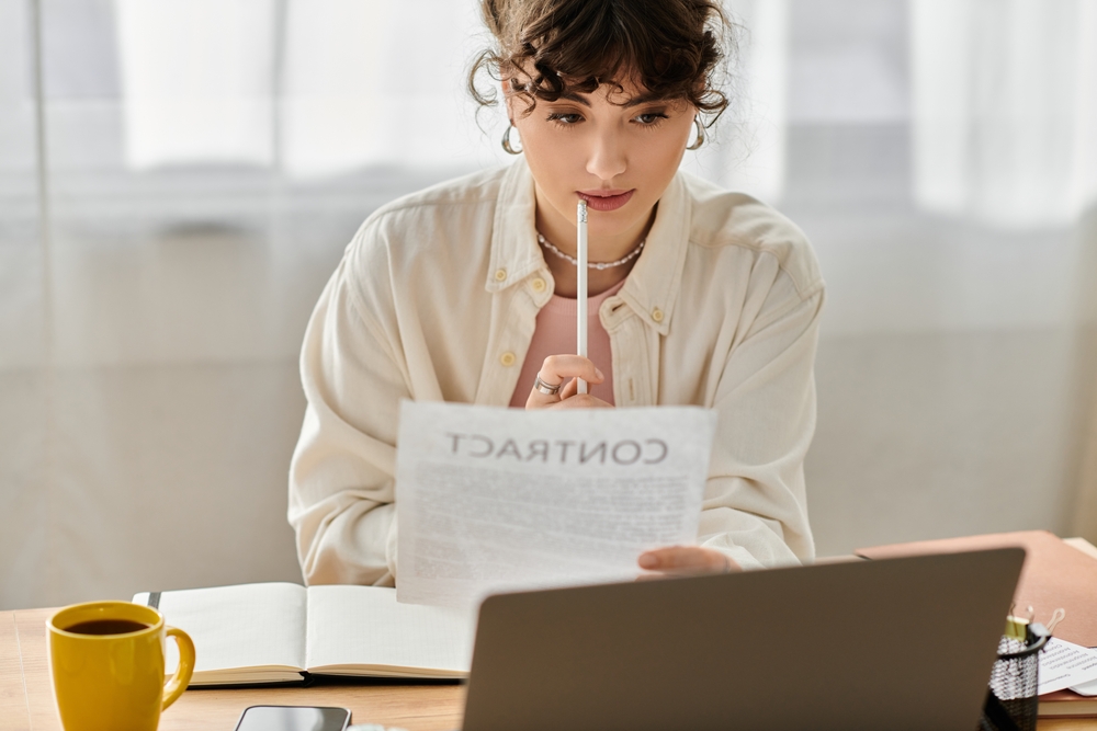 Business Woman Thoughtfully Reviews A Contract