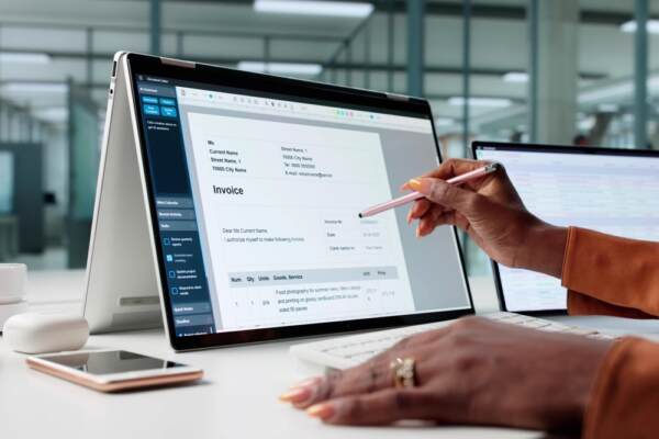 Worker Using Electronic Invoice Accounting Software On Digital Laptop