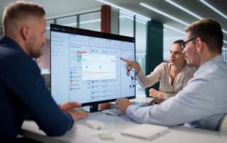 Team Of Financial Analysts Reviews Cloud-based Invoice Data Together
