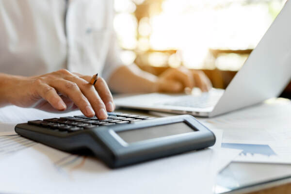 Close Up Businessman Pressing On Calculator